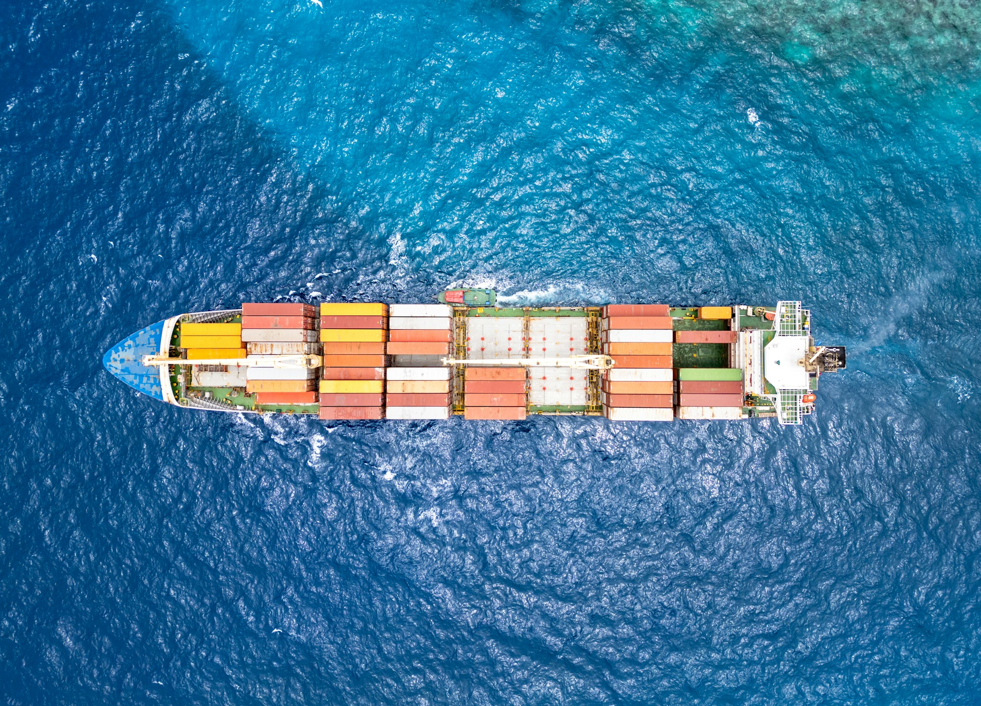 An aerial view of a container ship at sea